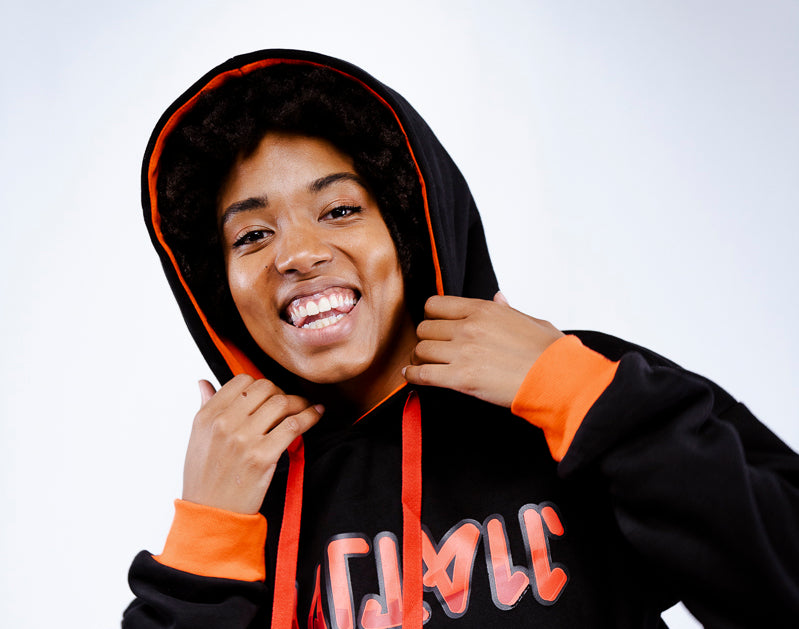 girl with black pullover with red logo and red cuffs