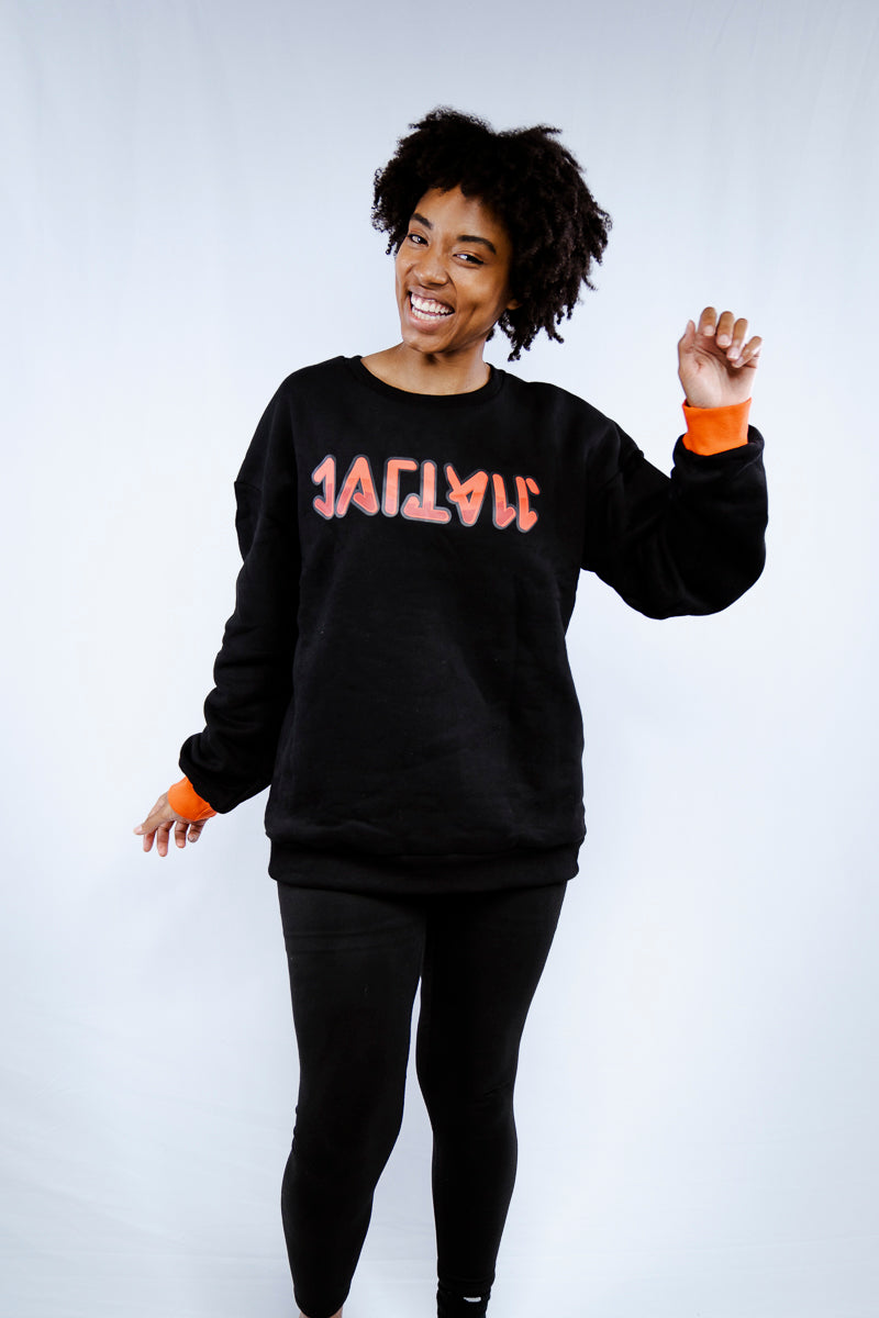 natural curly afro hair girl in black pullover with red cuffs and red text